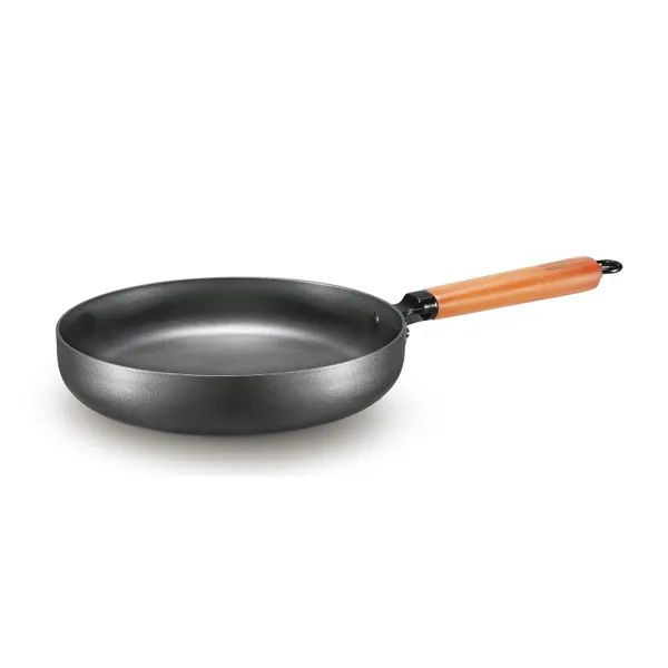 A carbon steel frying pan with sloped sides and a long wooden handle, the lighter alternative to a cast iron skillet
